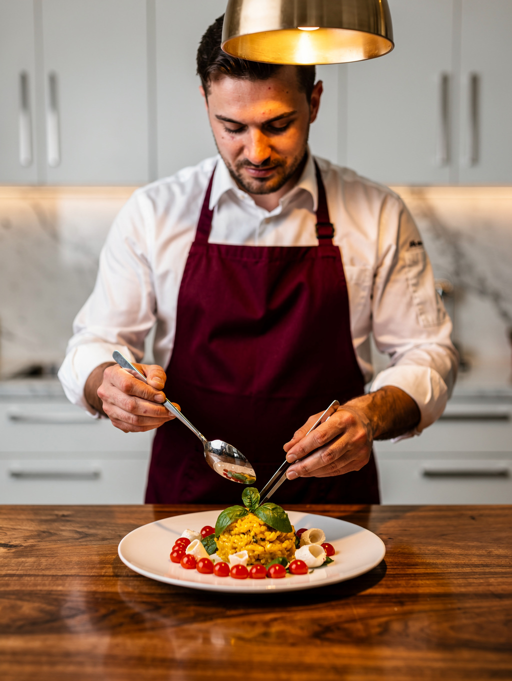 Chef plating a seasonal Italian dish with precision